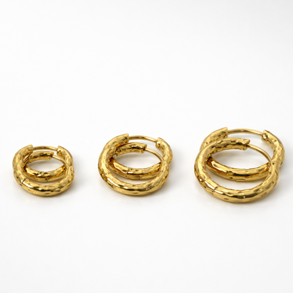 Three pairs of gold hoop earrings side by side, in size 8mm, 10mm and 12mm on a white background