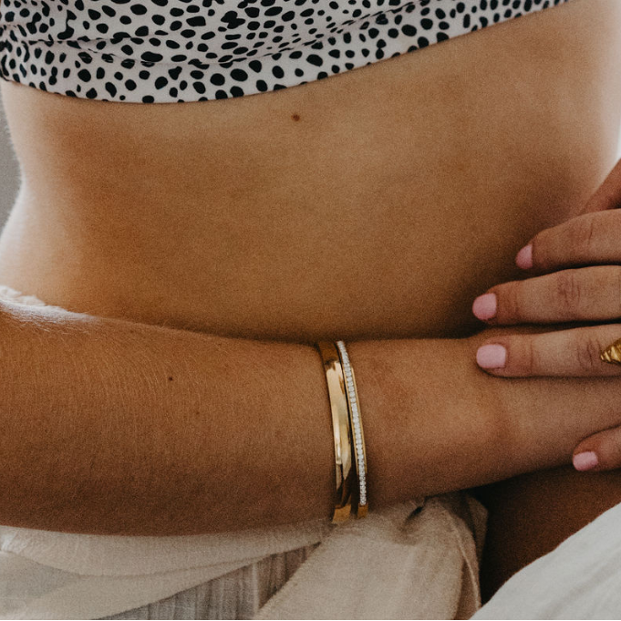 model wearing Eclipse herringbone necklace layered with gold waterproof necklaces and everyday jewelry