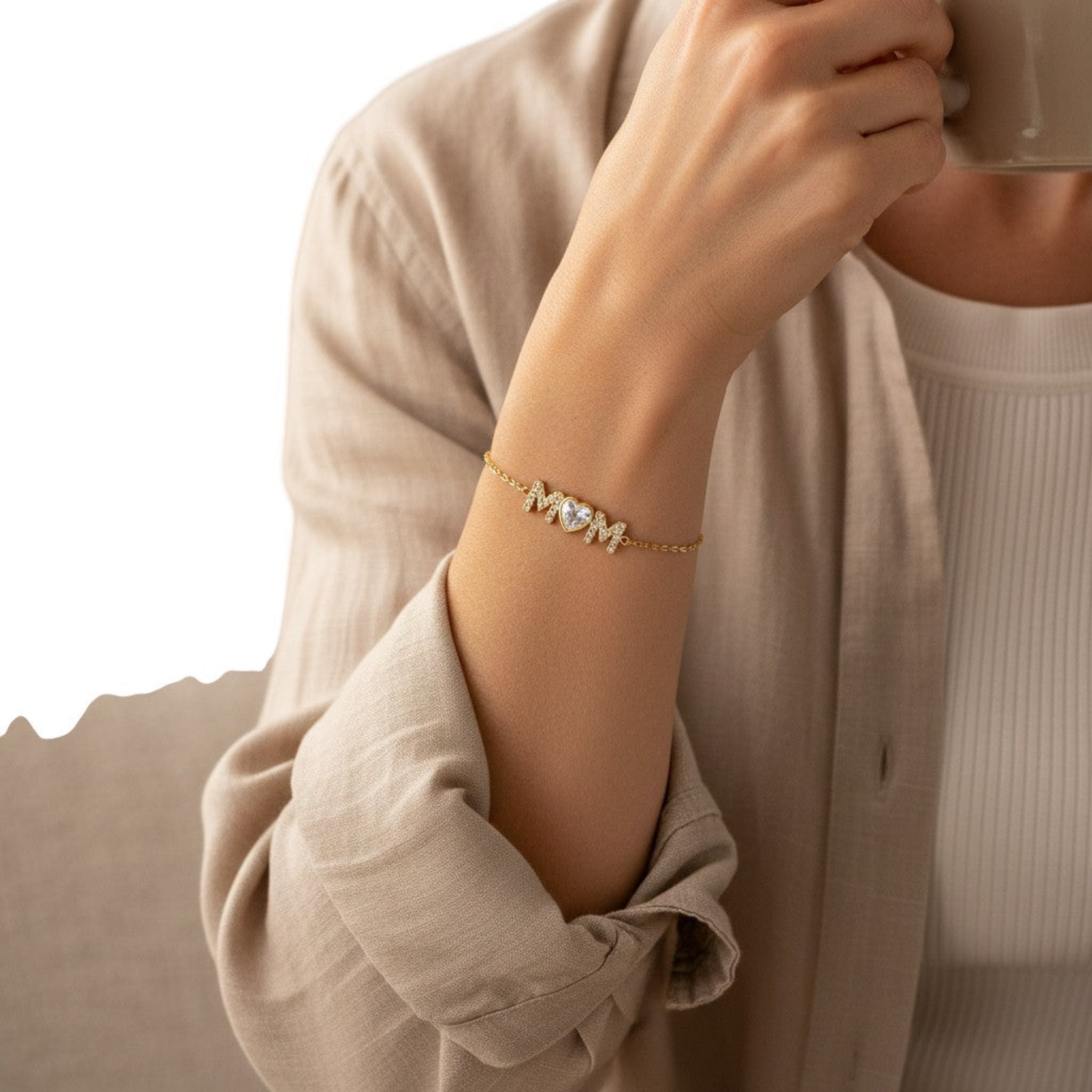 Woman wearing Mom Radiance bracelet with heart CZ detail in everyday setting, waterproof gold jewelry designed for daily wear