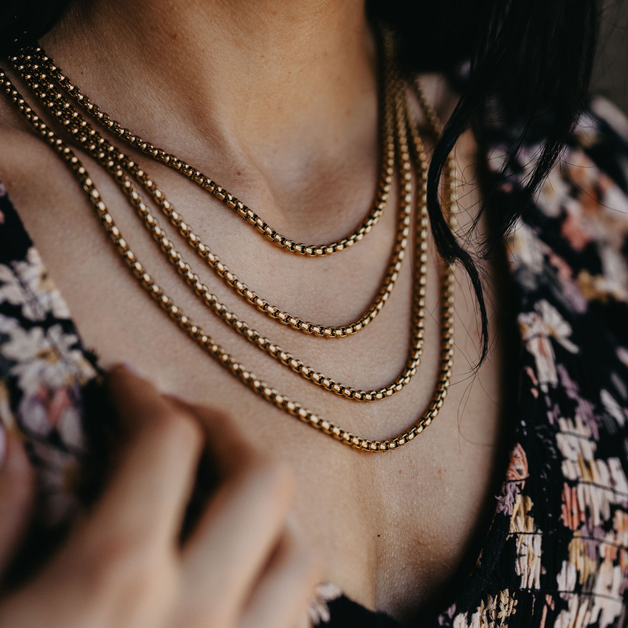 close up of Reefline rounded box chain necklaces in 18K gold PVD with polished link texture