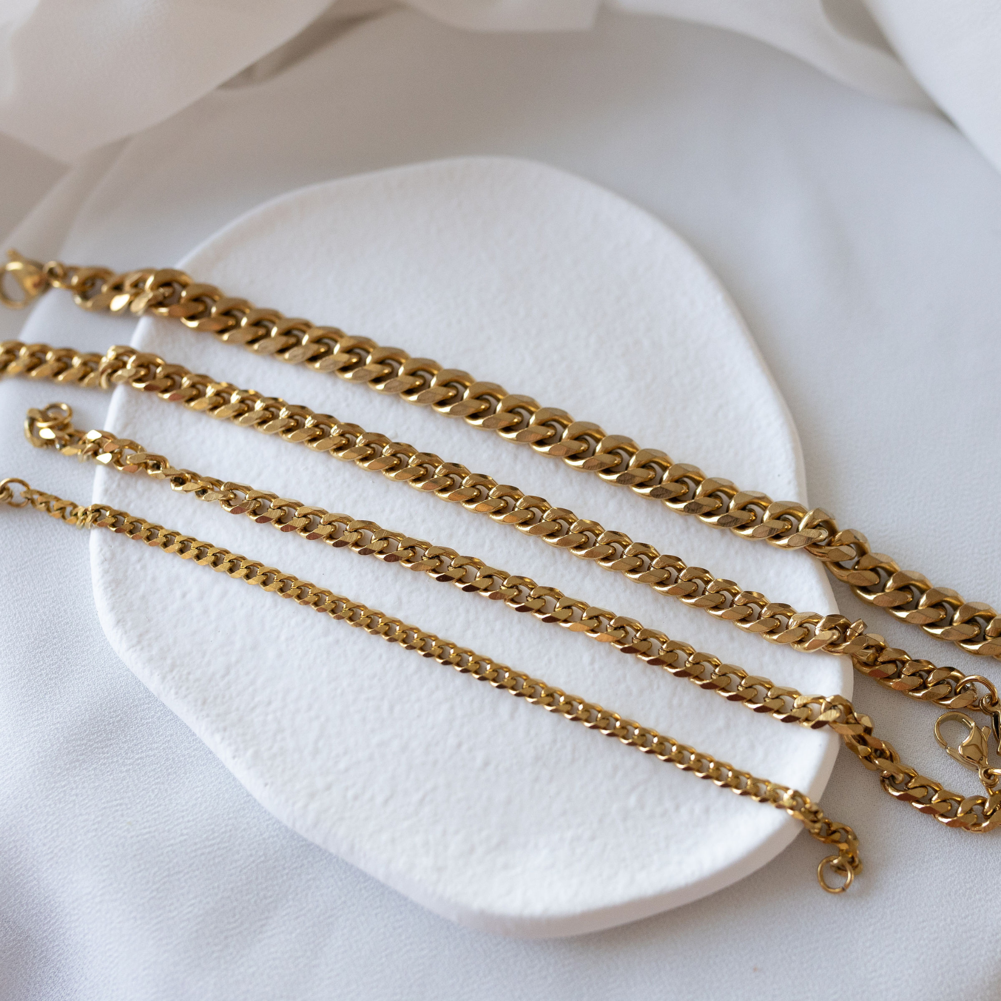 Sunseeker gold Cuban link bracelets in 18K gold PVD displayed in multiple widths waterproof jewelry