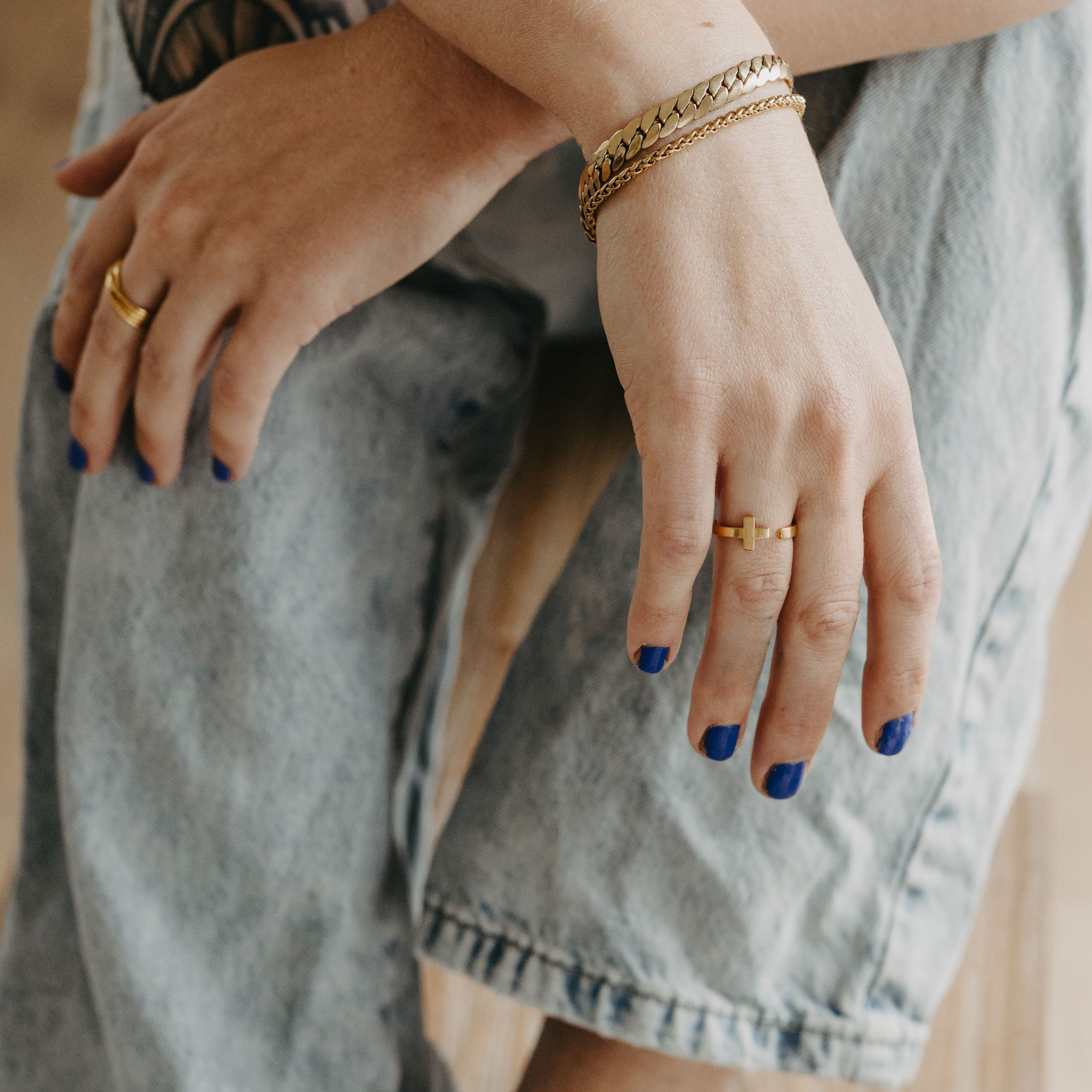 model wearing Surfside 3mm wheat chain bracelet in 18K gold PVD with everyday layered jewelry