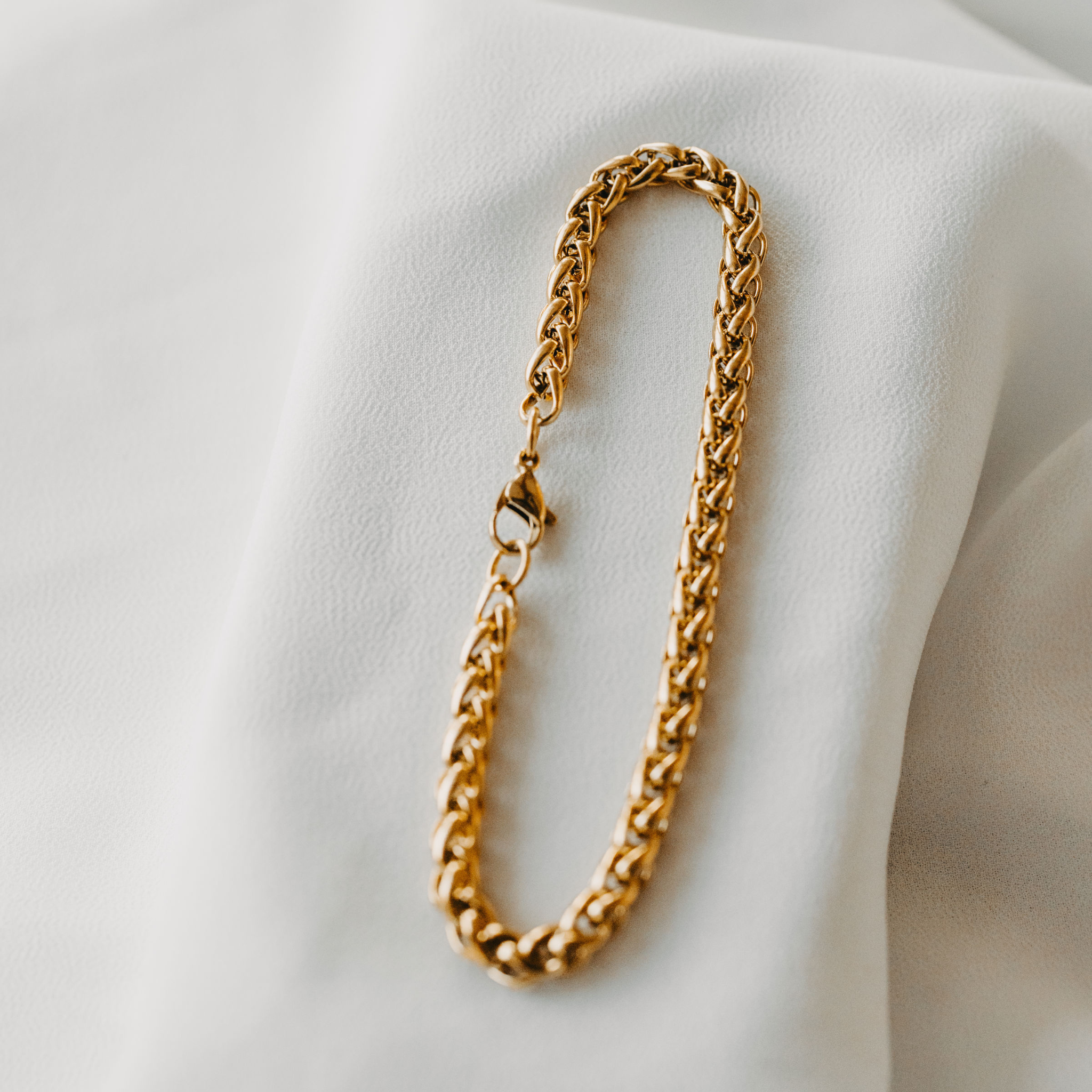 Surfside 5mm wheat chain bracelet in 18K gold PVD on white display waterproof tarnish resistant jewelry