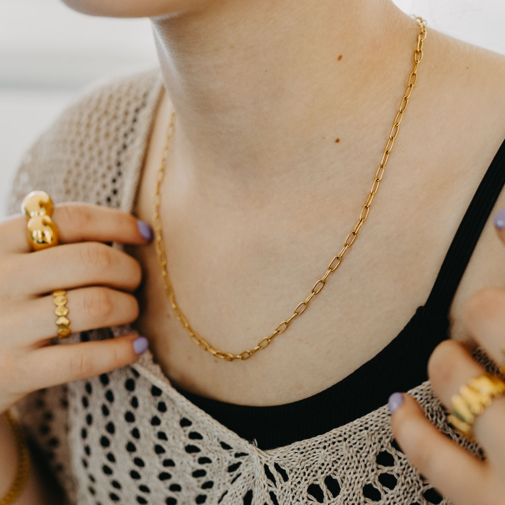 Model showing front detail on the waterproof gold paperclip chain