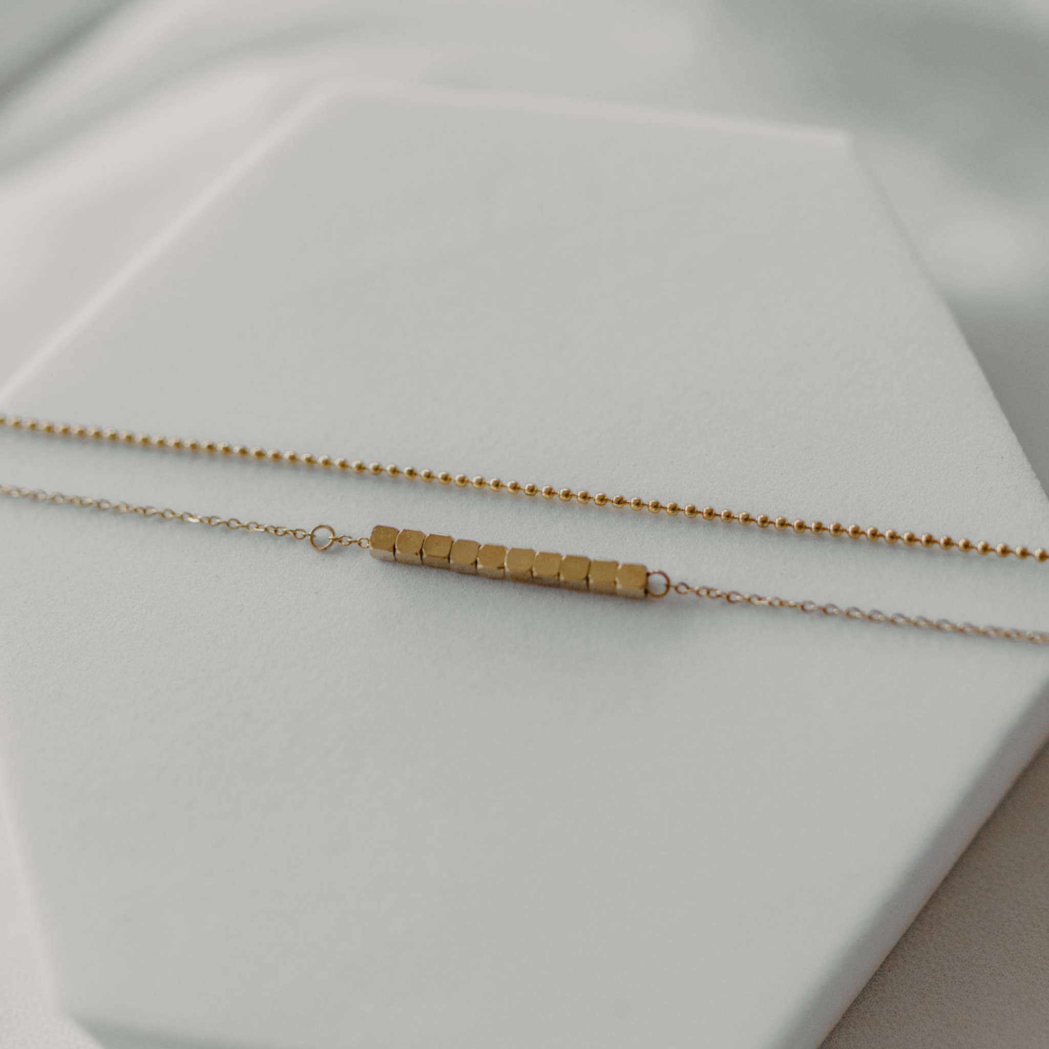 Close up of the square beads and fine details of  the waterproof gold layered anklet. 