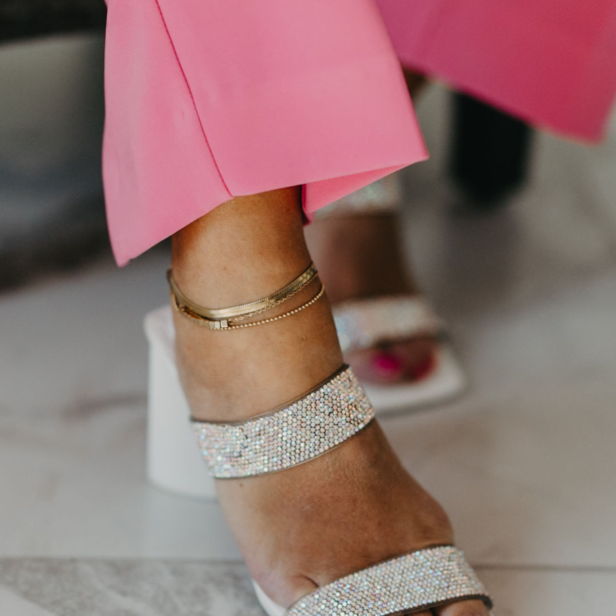 Model showing the style versatility of  Aphrodite Waterproof Gold Layered Anklet, stacked with the Eclipse Waterproof Gold Herringbone Anklet. 