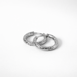 Aura hoop earrings in silver stainless steel with hammered texture in huggie style on white background 3