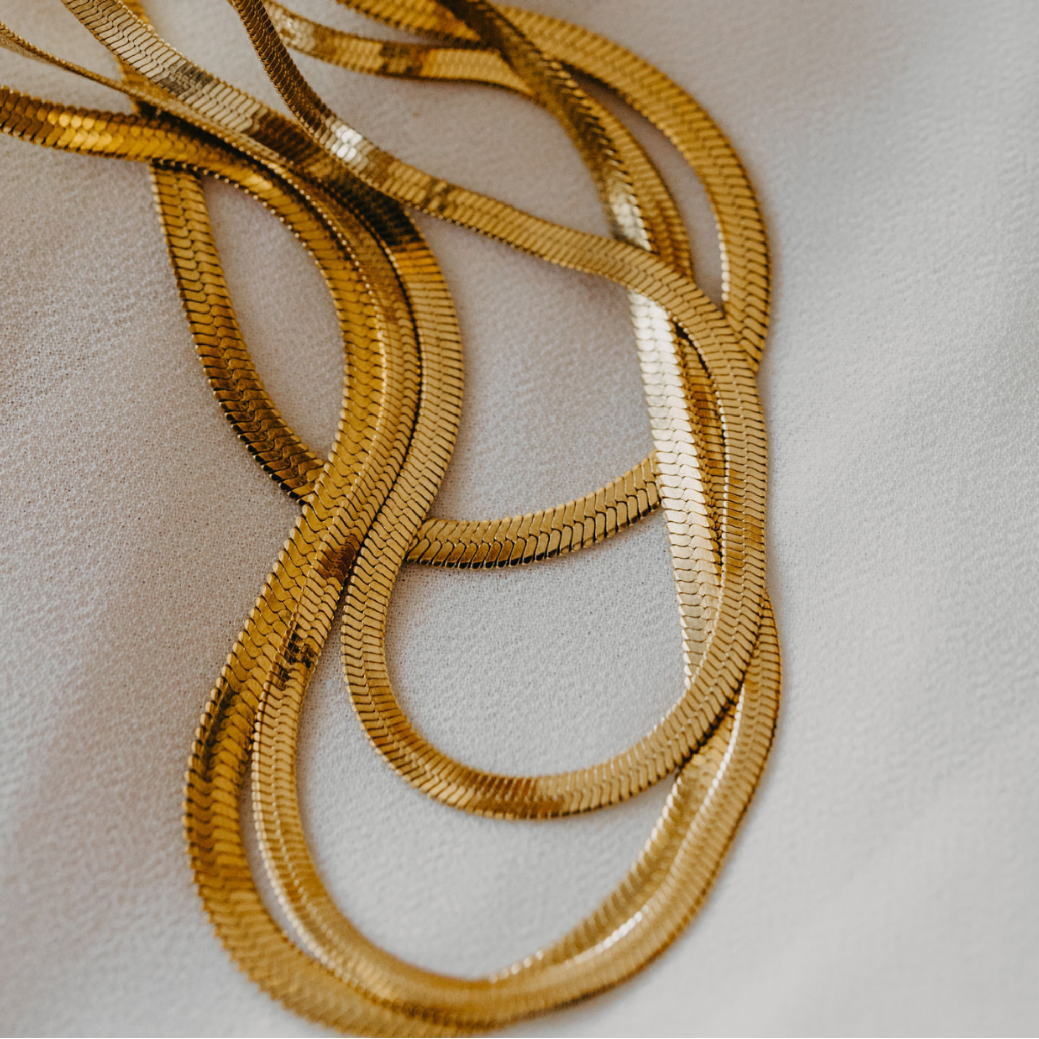 Eclipse herringbone necklace in 18K gold PVD with smooth reflective finish waterproof jewelry