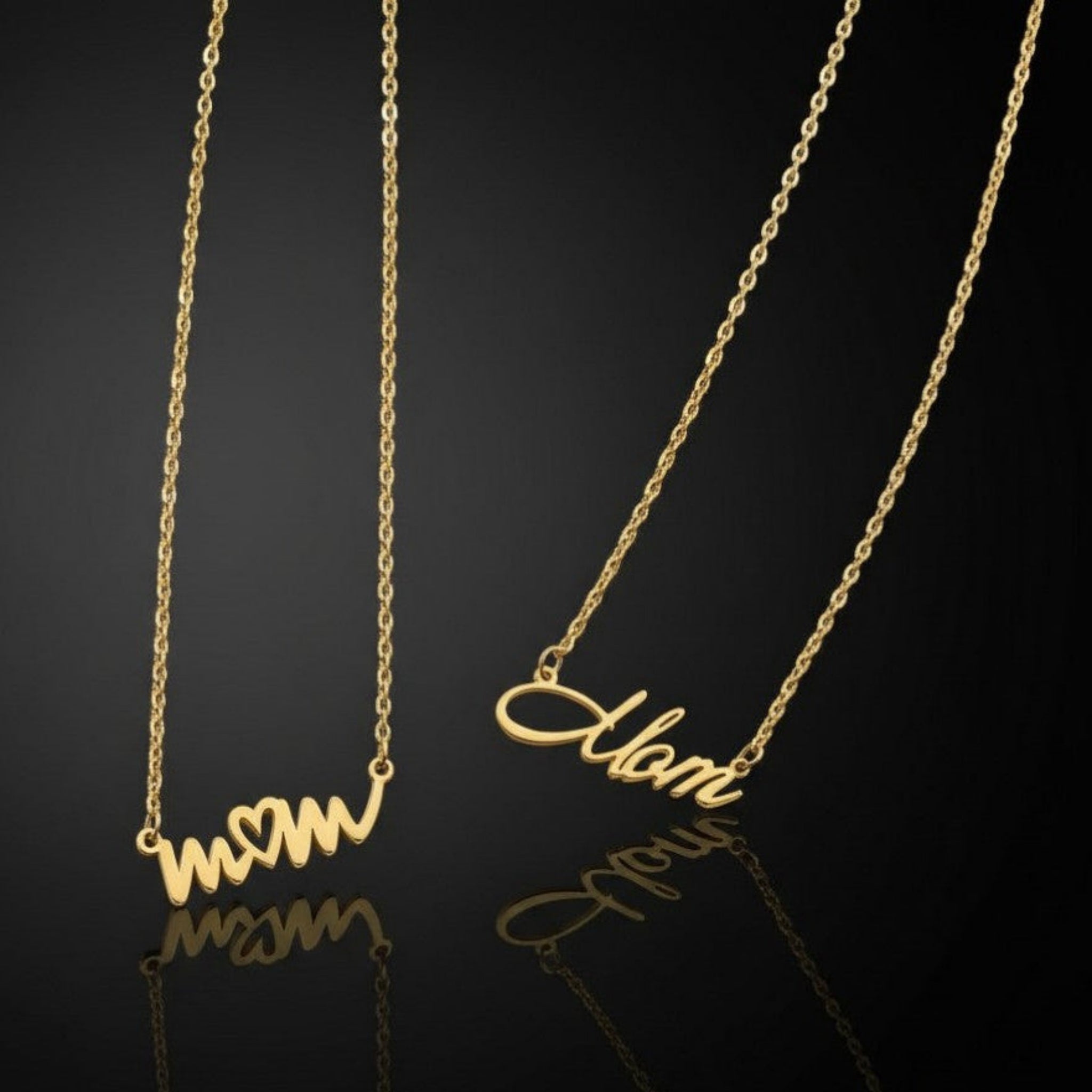 two Forever Mom necklaces on black background showing handwritten mom design with heart and elegant script mom style in gold PVD