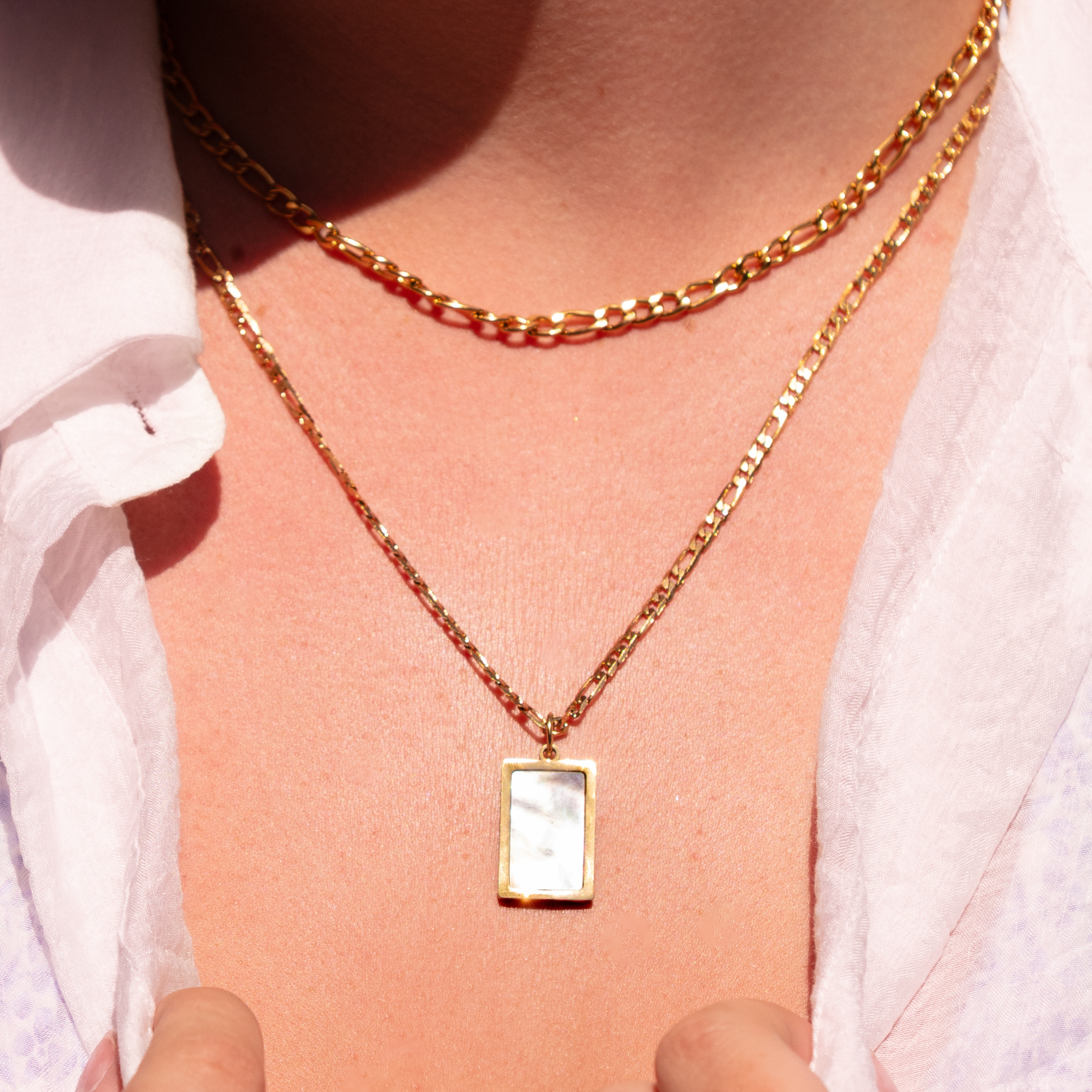 close up of Forge figaro chain necklace layered with gold pendant necklace, waterproof 18K gold PVD jewelry