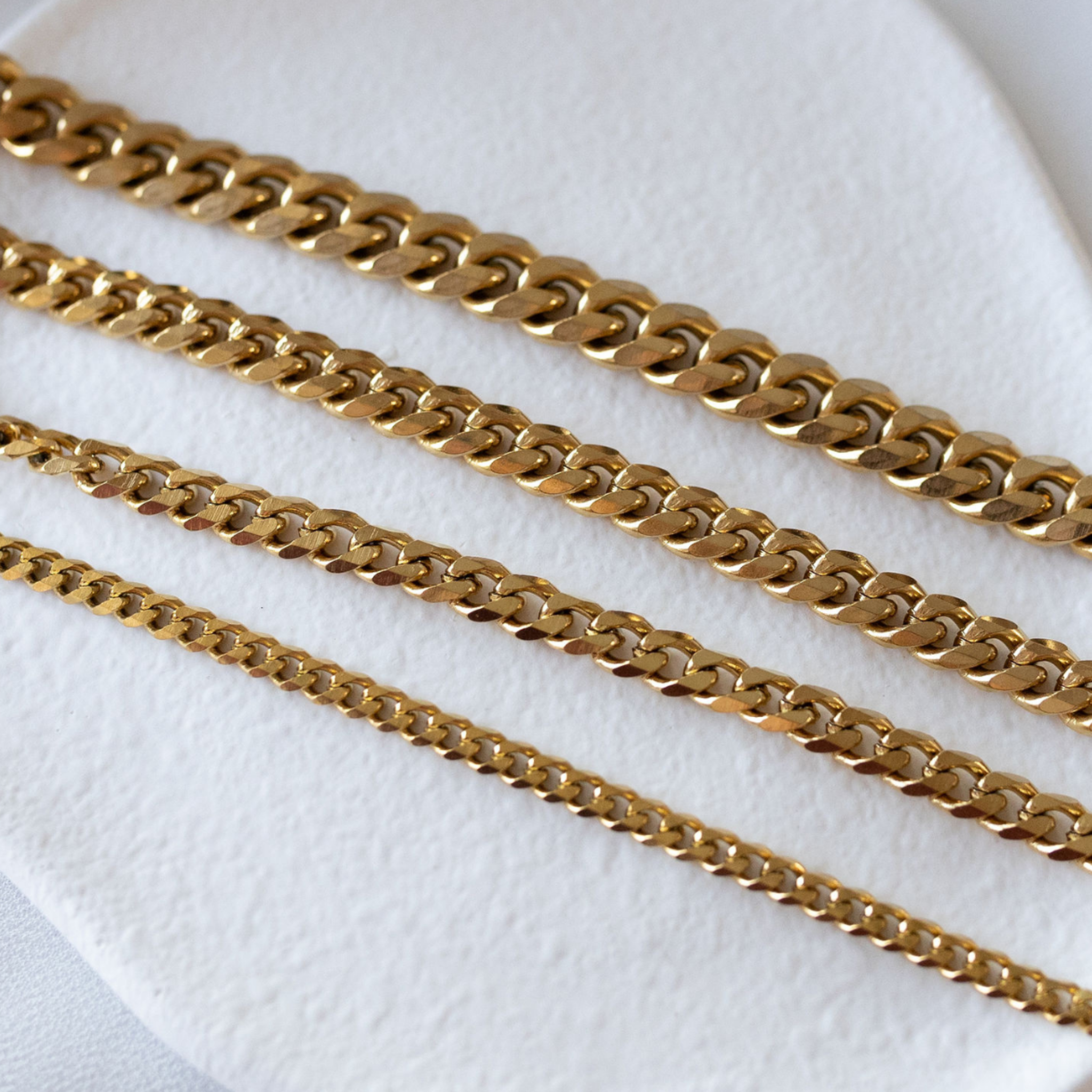 Sunseeker Cuban link bracelets in 18K gold PVD showing multiple width options waterproof jewelry